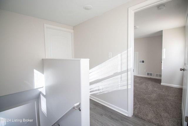 stairway with hardwood / wood-style flooring