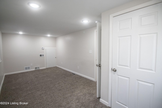 basement with dark colored carpet