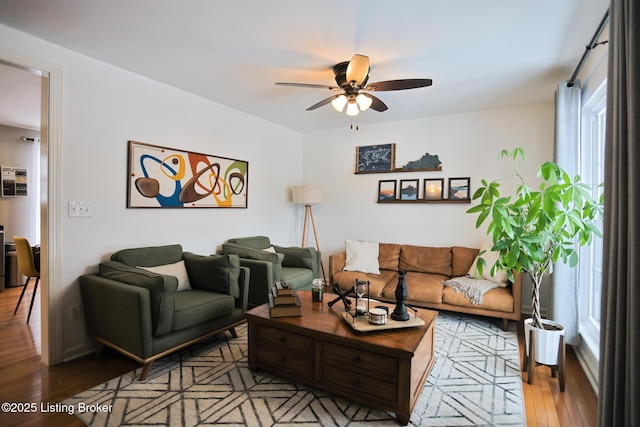 living room featuring ceiling fan and light wood-type flooring