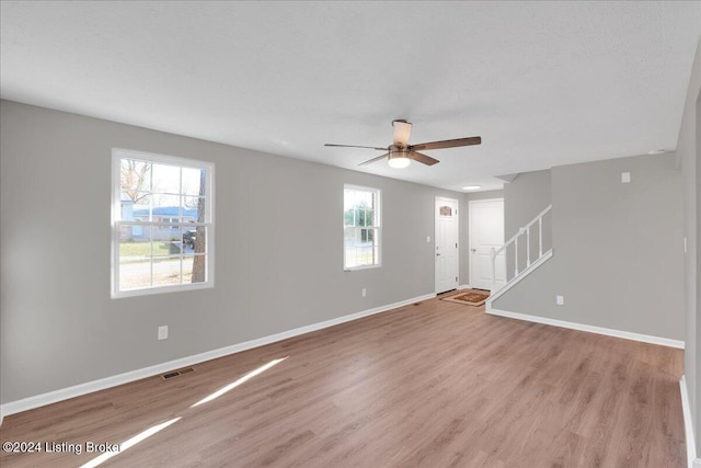 spare room featuring a textured ceiling, light hardwood / wood-style floors, and ceiling fan