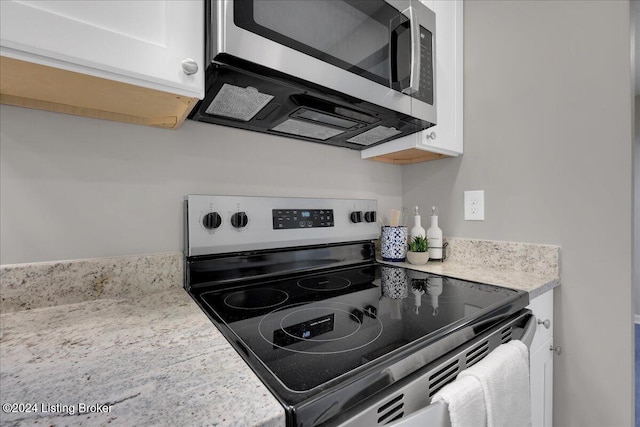 kitchen featuring white cabinets and appliances with stainless steel finishes