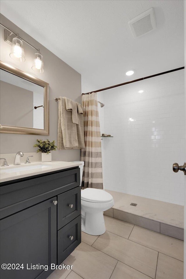 bathroom with tile patterned floors, vanity, and a shower with shower curtain