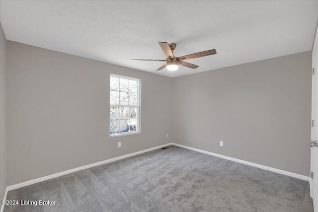 carpeted empty room with ceiling fan