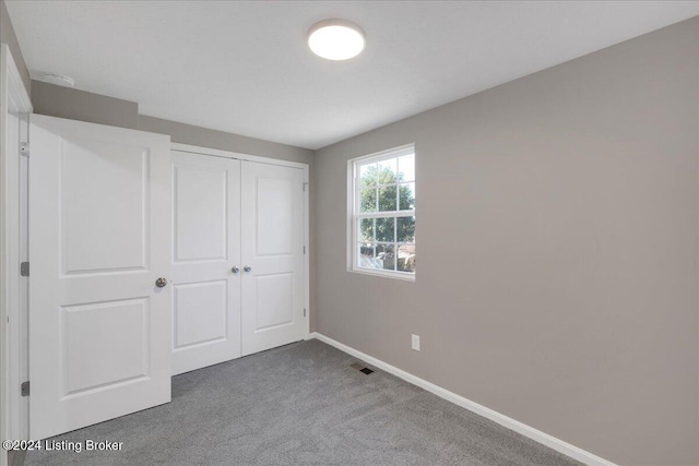 unfurnished bedroom with carpet floors and a closet