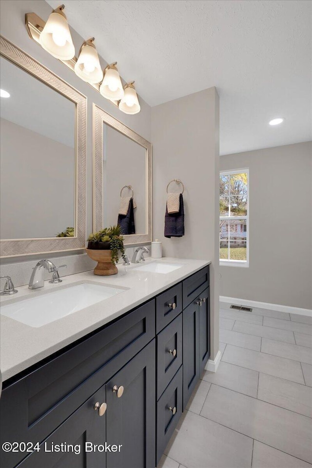 bathroom featuring tile patterned flooring and vanity