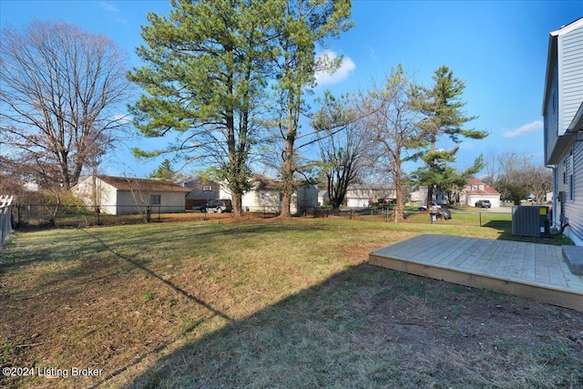 view of yard featuring central AC unit and a wooden deck