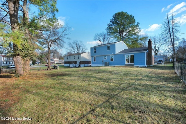 back of house with a lawn and cooling unit