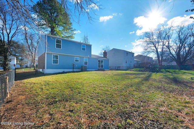 back of property featuring a yard