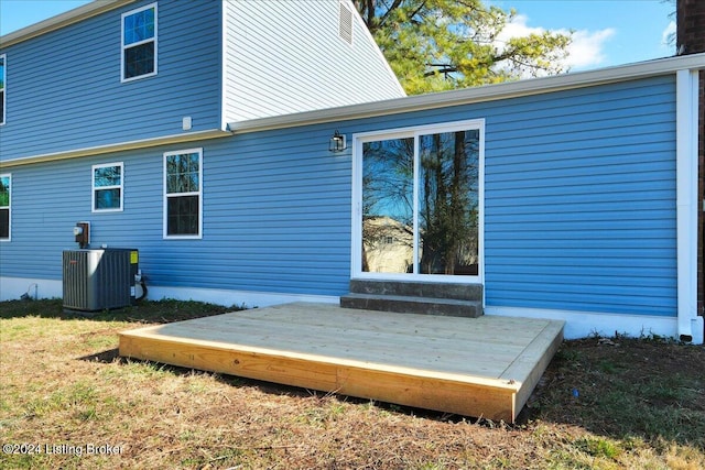 back of property featuring a deck and central AC