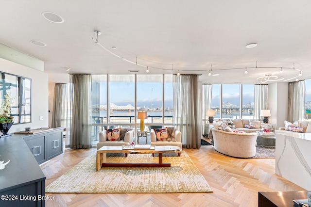 interior space featuring light parquet flooring, a water view, and expansive windows