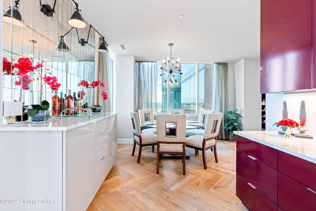 dining room featuring light parquet floors and a chandelier