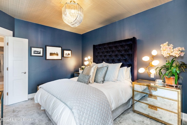 bedroom with wooden ceiling, light carpet, and an inviting chandelier