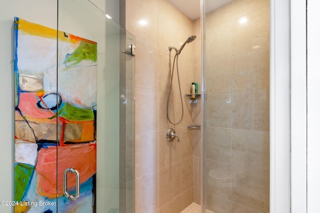 bathroom with a shower with shower door