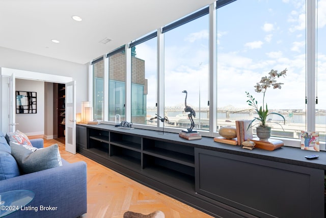 bar with a water view and light parquet flooring