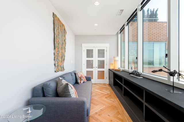 living area featuring french doors and light parquet flooring