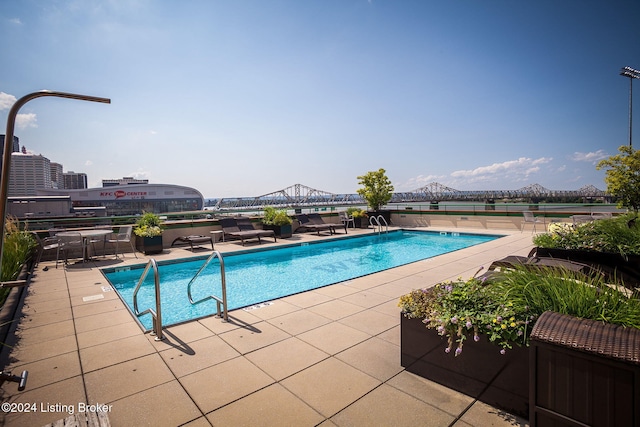 view of pool featuring a mountain view and a patio