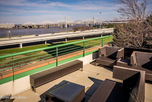 view of patio / terrace featuring an outdoor living space, a balcony, and a water view