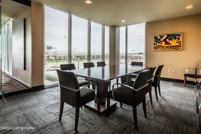 carpeted dining area with plenty of natural light and floor to ceiling windows