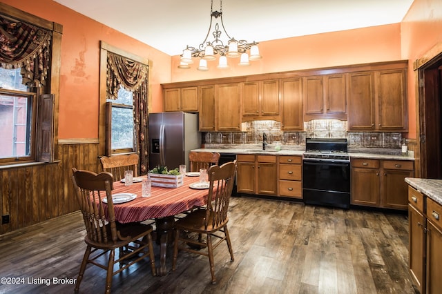 kitchen featuring sink, hanging light fixtures, stainless steel fridge with ice dispenser, backsplash, and range with gas stovetop