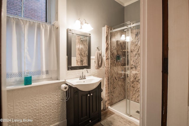 bathroom featuring tiled shower, vanity, and ornamental molding