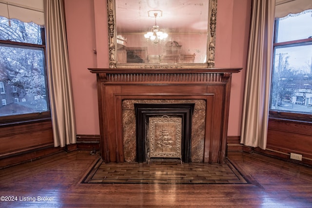 room details featuring wooden walls, hardwood / wood-style floors, and a chandelier