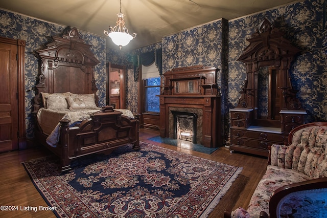 bedroom featuring dark hardwood / wood-style floors and a premium fireplace