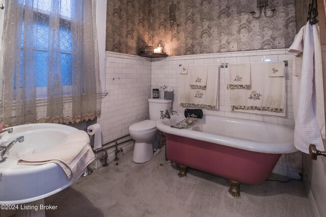 bathroom with a bath, toilet, and tile walls