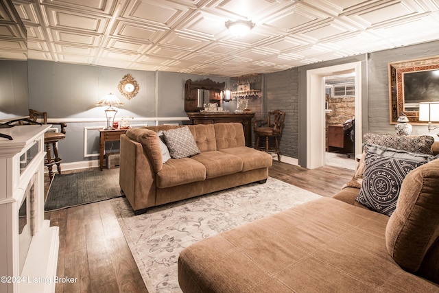 living room featuring wood-type flooring and indoor bar