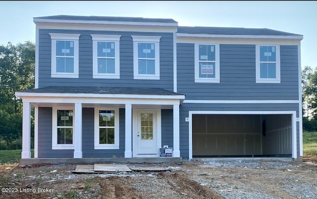 view of front facade with a porch and a garage