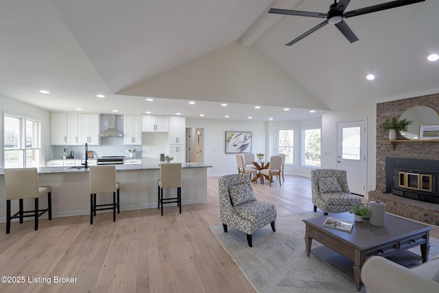 9415 Rockycreek Ln, Louisville, KY 40299 - living area with light wood finished floors, plenty of natural light, beamed ceiling, and high vaulted ceiling