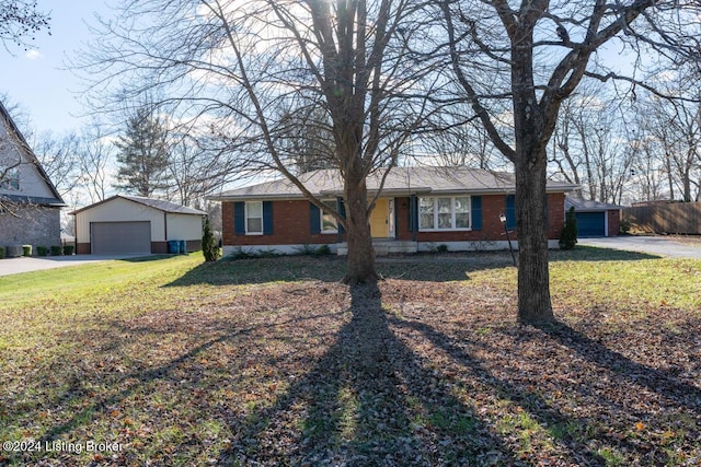 single story home featuring an outbuilding, a front yard, and a garage