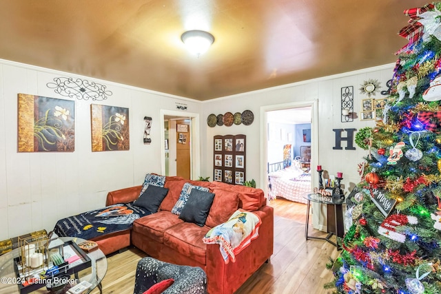 living room with crown molding and light hardwood / wood-style floors