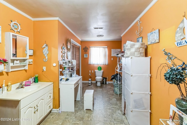 bathroom with crown molding, sink, and toilet