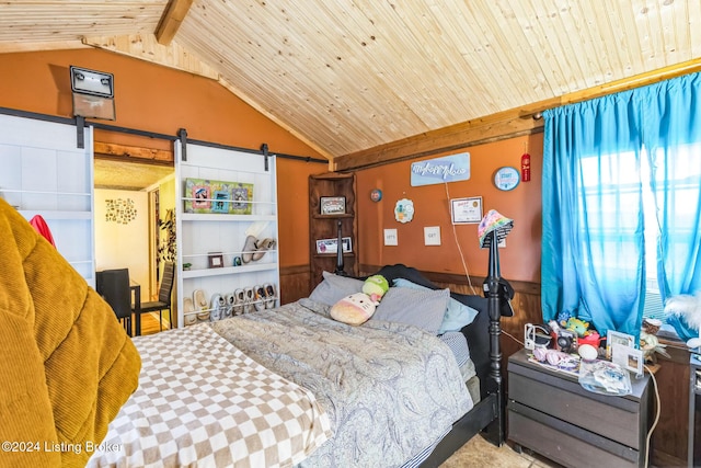 bedroom with vaulted ceiling with beams, a barn door, and wood ceiling