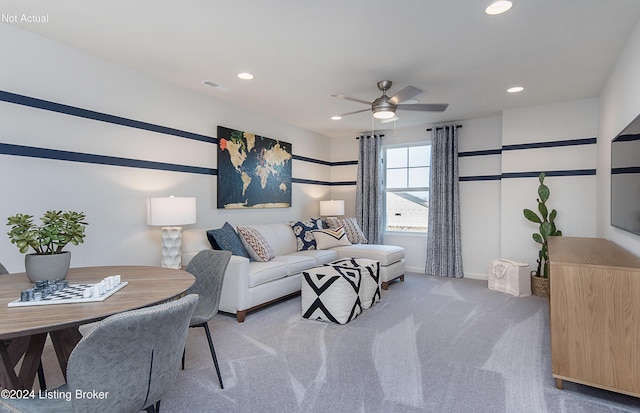 living room featuring ceiling fan and carpet