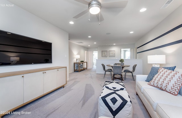 living room featuring light carpet and ceiling fan