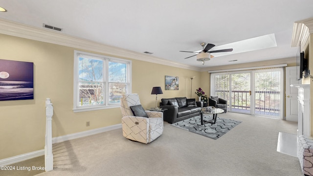 living room with light carpet, ceiling fan, and ornamental molding