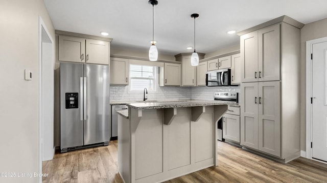 389 Williamsburg Dr, Mt Washington, KY 40047 - kitchen with light wood finished floors, gray cabinets, light stone counters, and stainless steel appliances