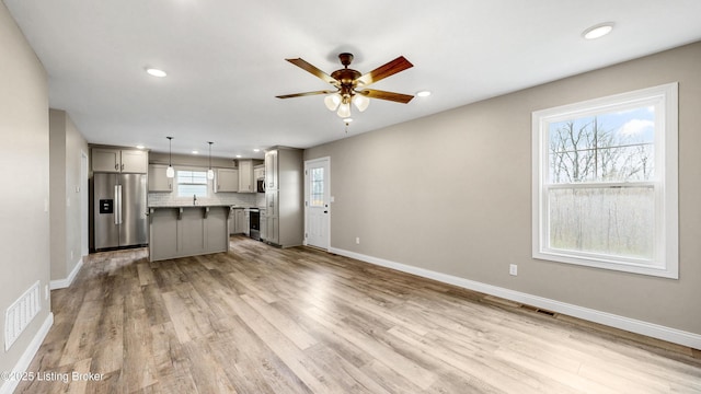 389 Williamsburg Dr, Mt Washington, KY 40047 - kitchen featuring visible vents, ceiling fan, a kitchen island, stainless steel refrigerator with ice dispenser, and gray cabinetry