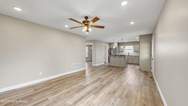 389 Williamsburg Dr, Mt Washington, KY 40047 - unfurnished living room featuring recessed lighting, baseboards, light wood finished floors, ceiling fan, and visible vents