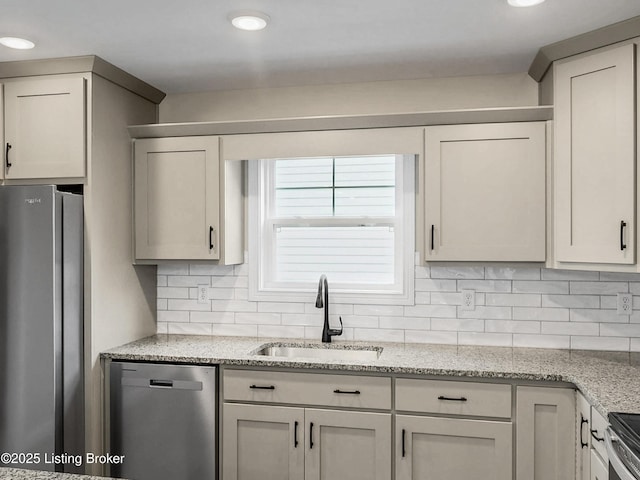 389 Williamsburg Dr, Mt Washington, KY 40047 - kitchen featuring a sink, light stone countertops, decorative backsplash, and appliances with stainless steel finishes