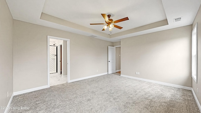 389 Williamsburg Dr, Mt Washington, KY 40047 - empty room with a tray ceiling, baseboards, visible vents, and light carpet