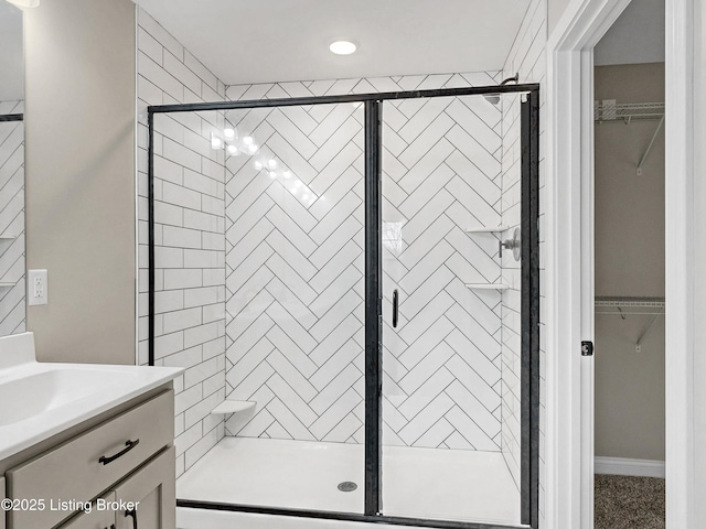 389 Williamsburg Dr, Mt Washington, KY 40047 - full bathroom featuring vanity, a walk in closet, and a stall shower