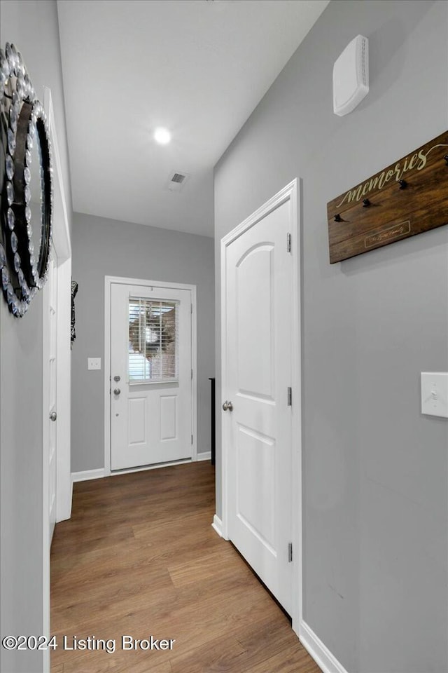 hall with light hardwood / wood-style floors