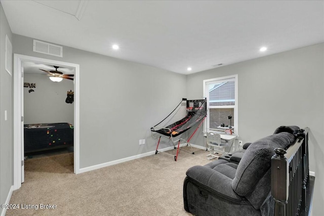 rec room with ceiling fan and light carpet