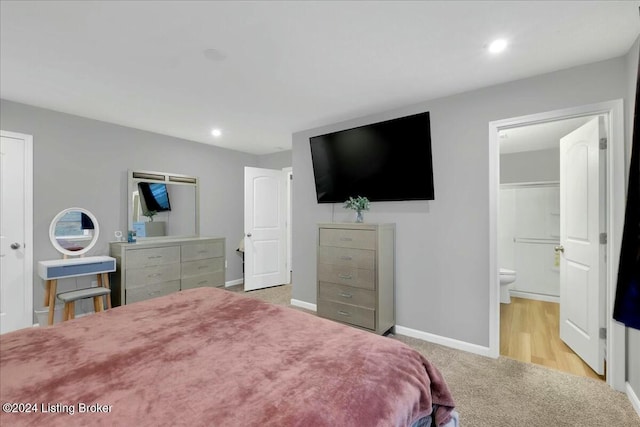 carpeted bedroom featuring ensuite bath