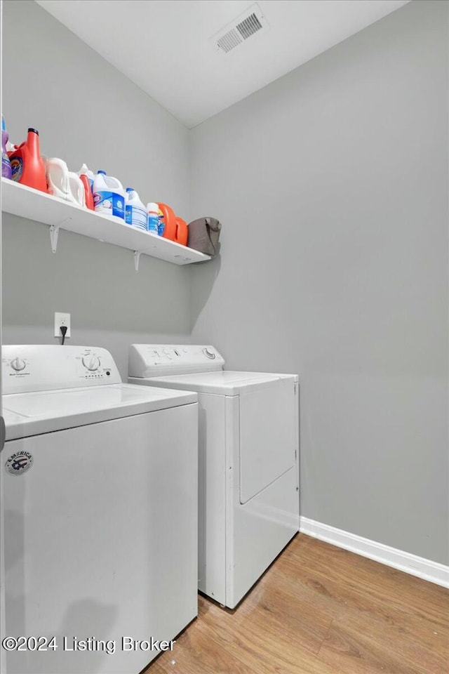 washroom featuring light wood-type flooring and separate washer and dryer