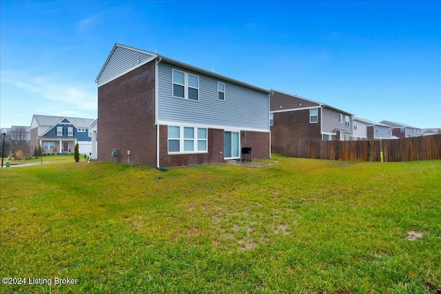 rear view of property with a yard