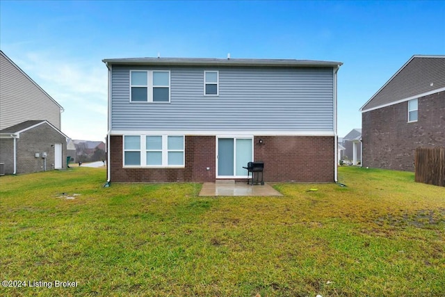 rear view of property featuring a patio area and a yard