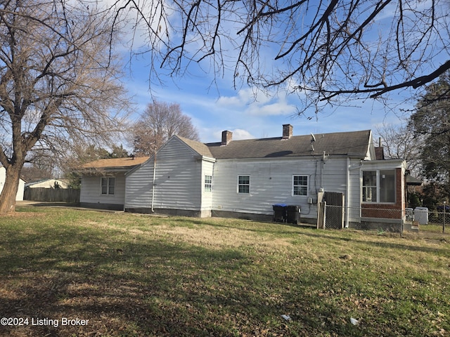 back of property featuring a yard